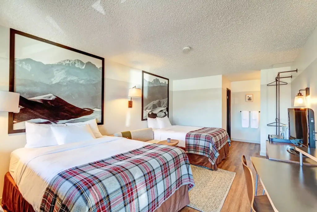 Hotel room with two beds and art on wall